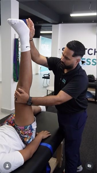 Stretch Room PR professional assisting a client during a stretching session